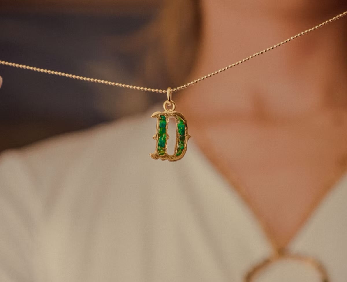 Letter pendant with resin-coated emerald chain coin